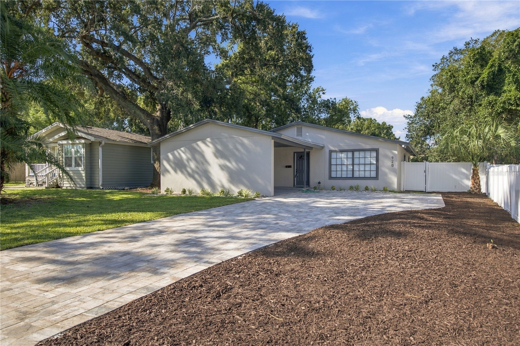 Front approach with new paver driveway and landscaping